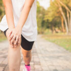 Young Female Stretching Before Fitness Training Session At The Park. Healthy Young Woman Warming Up Outdoors. She Is Stretching Her Arms And Looking Away,hi Key. Vintage Effect Style Pictures.